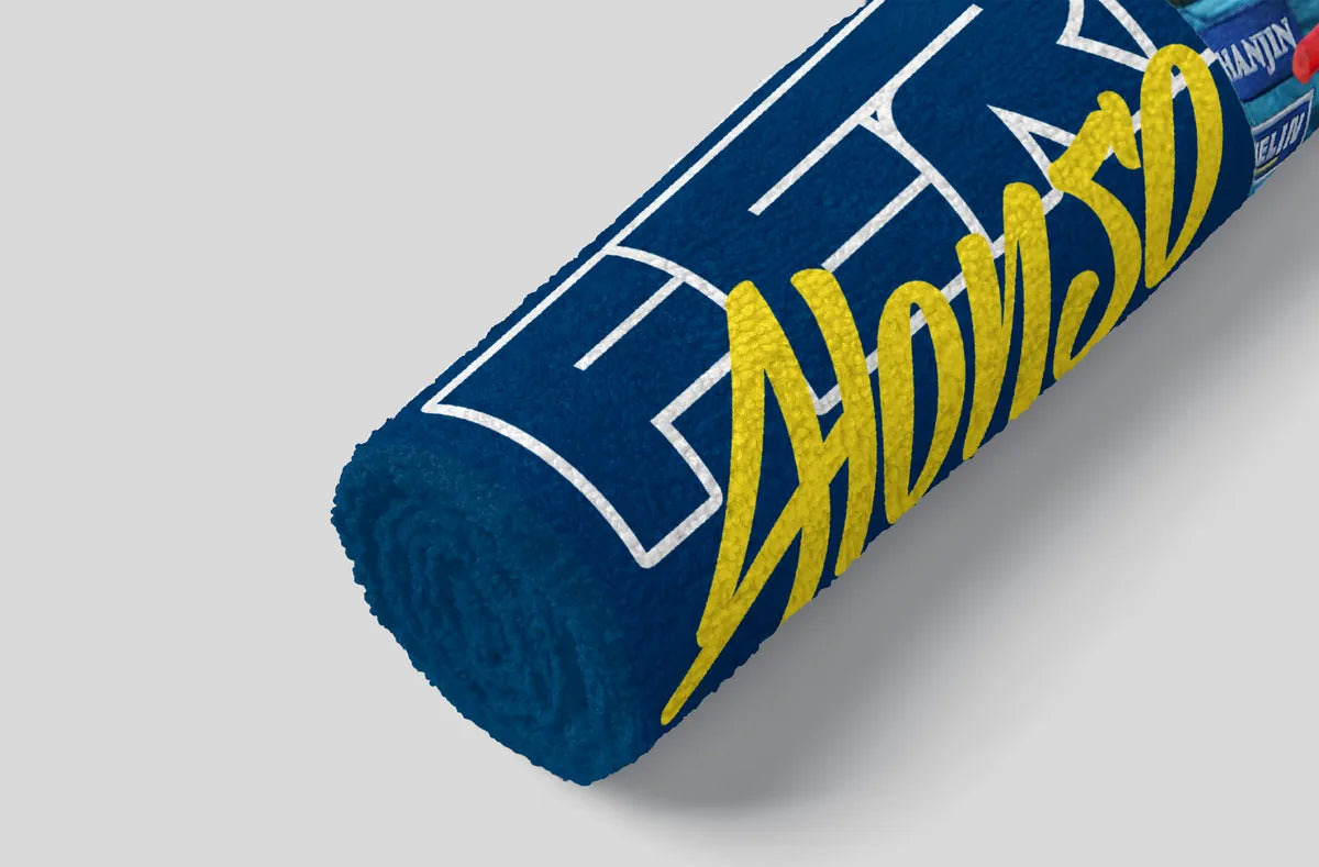 Blue towel with yellow text on a gray background