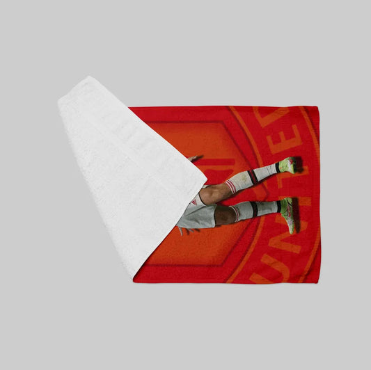 Person lying on a red towel with a white border on a gray background