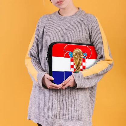 Person holding a pouch with a World Cup design against an orange background