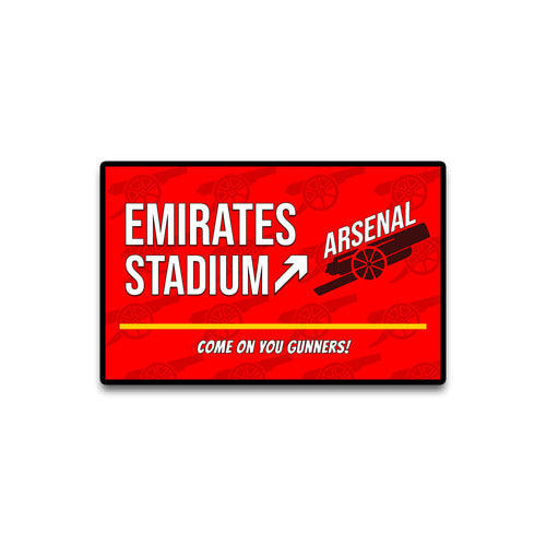 Red sign with Arsenal branding and text about Emirates Stadium on a white background