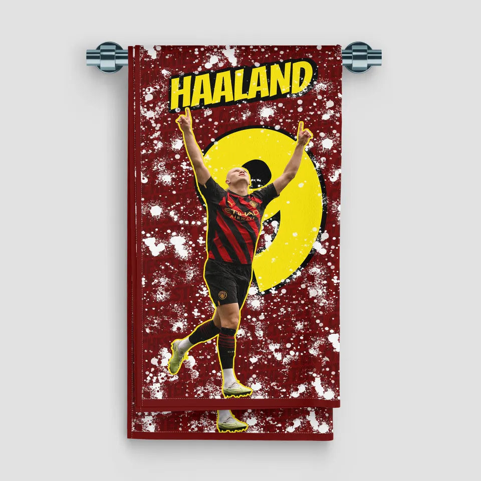 Towel with a soccer player in a red and yellow uniform on a red background with 'Haaland' text.
