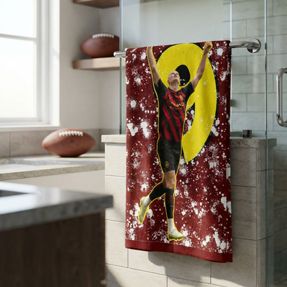Towel with a sports-themed design hanging in a bathroom