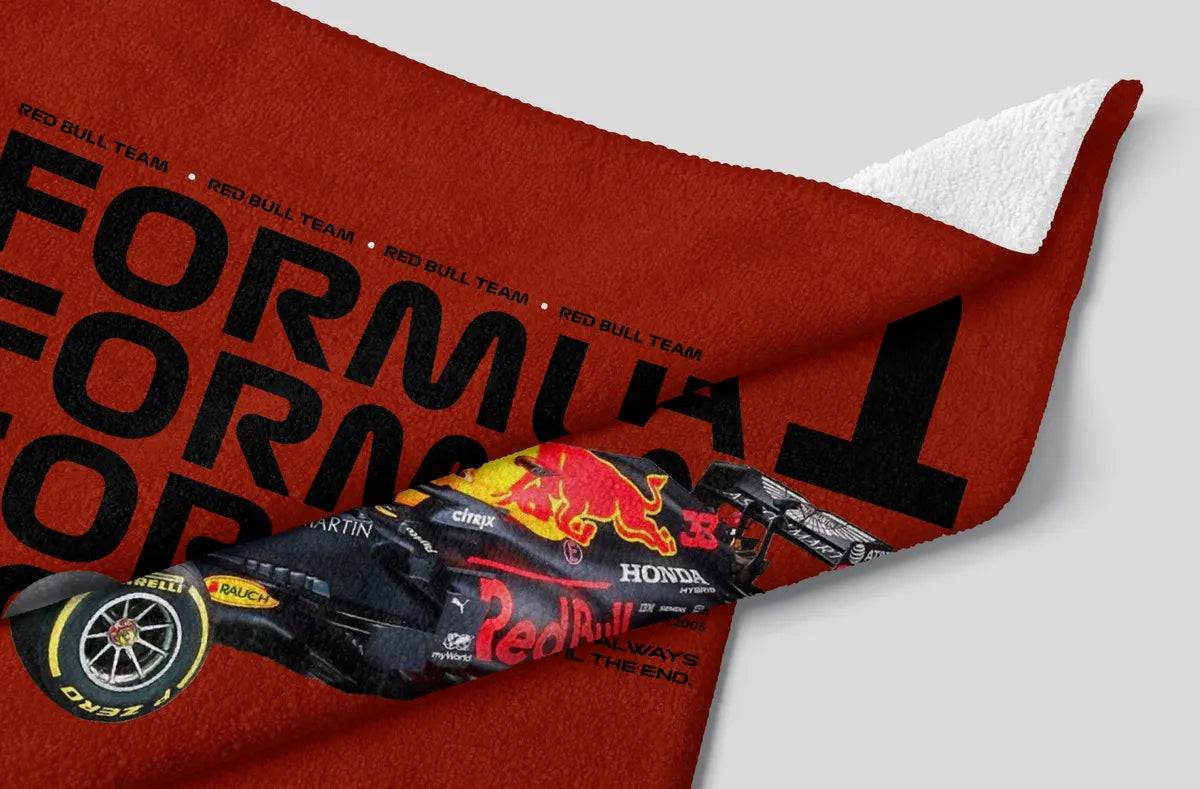 Red Bull Team Formula 1 car design on a red blanket with white corner.