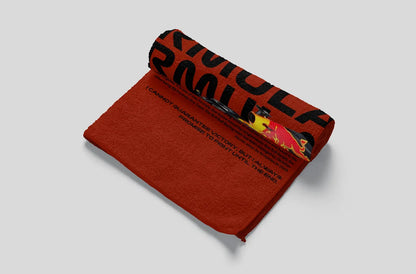 Red towel with black text and graphics on a light gray background