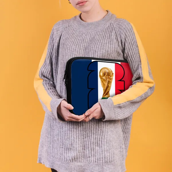 Person holding a pouch with a World Cup trophy design on an orange background