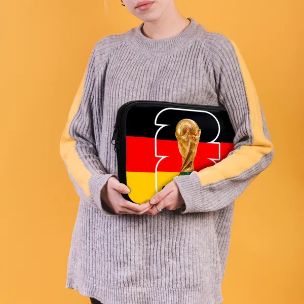 Person holding a pouch with German flag and World Cup trophy design on a yellow background