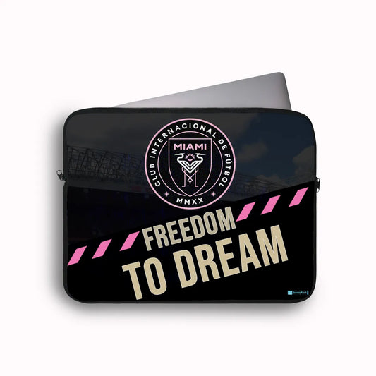 Laptop sleeve with Club Internacional de Fötbol logo and 'Freedom to Dream' text on a black background