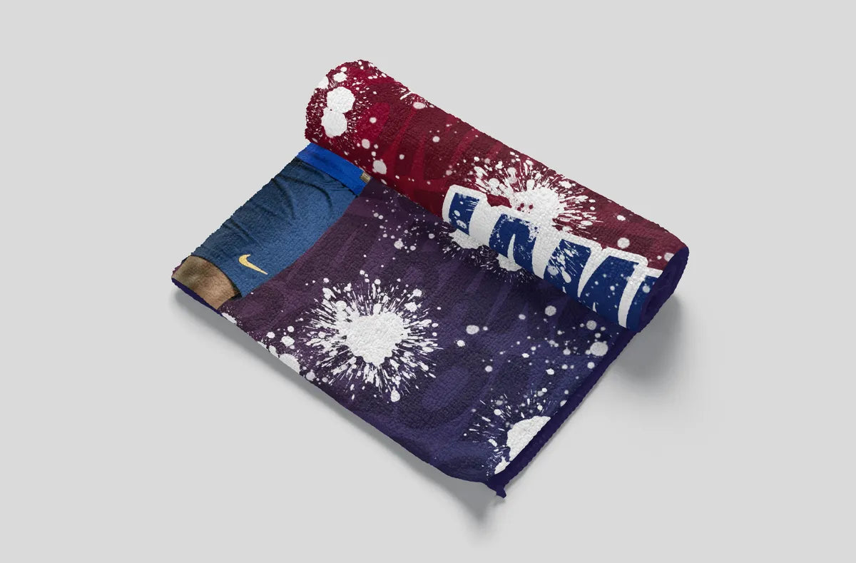 Folded fabric with splatter design and visible brand logo on a light gray background