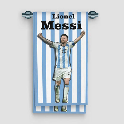 Towel with a graphic of a soccer player in a striped pattern, featuring the name 'Lionel Messi'.