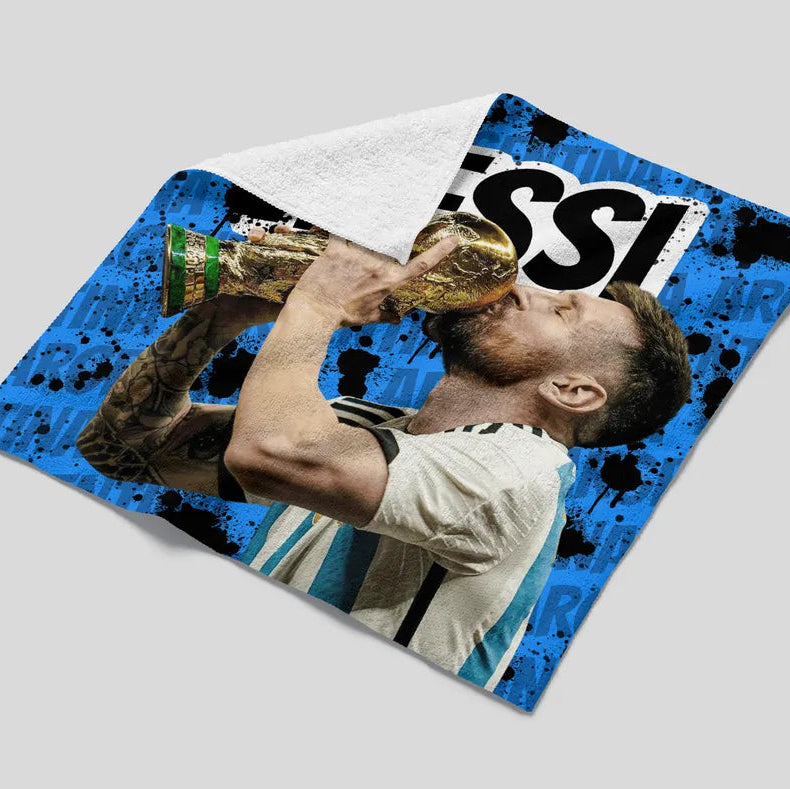 Towel with a sports player design and 'Messi' branding on a gray background