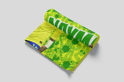 Roll of green and yellow patterned fabric on a gray background