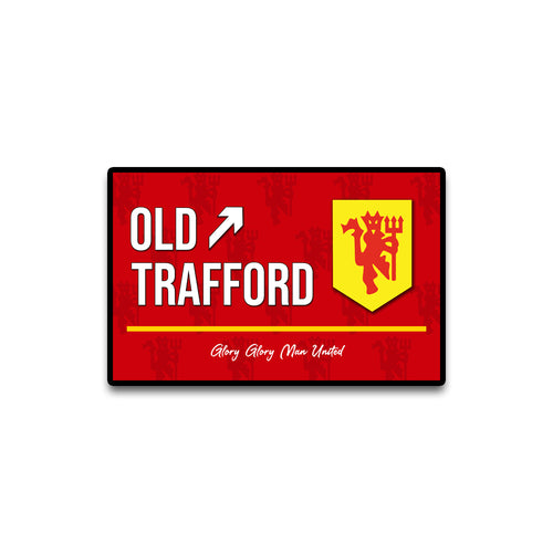 Red sign with 'Old Trafford' and a yellow logo on a white background