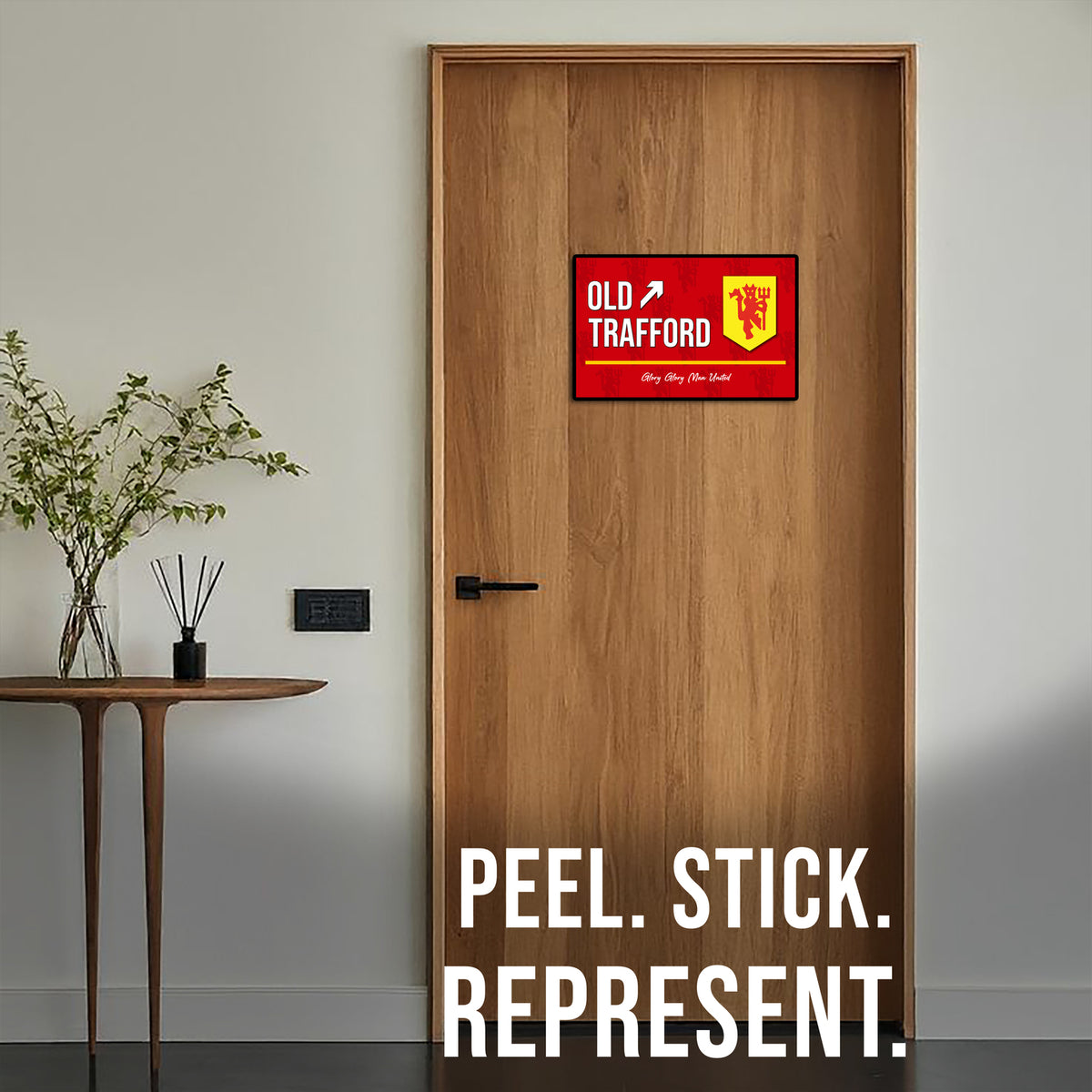 Wooden door with a red and white sign and text 'Old Trafford' on a neutral background.
