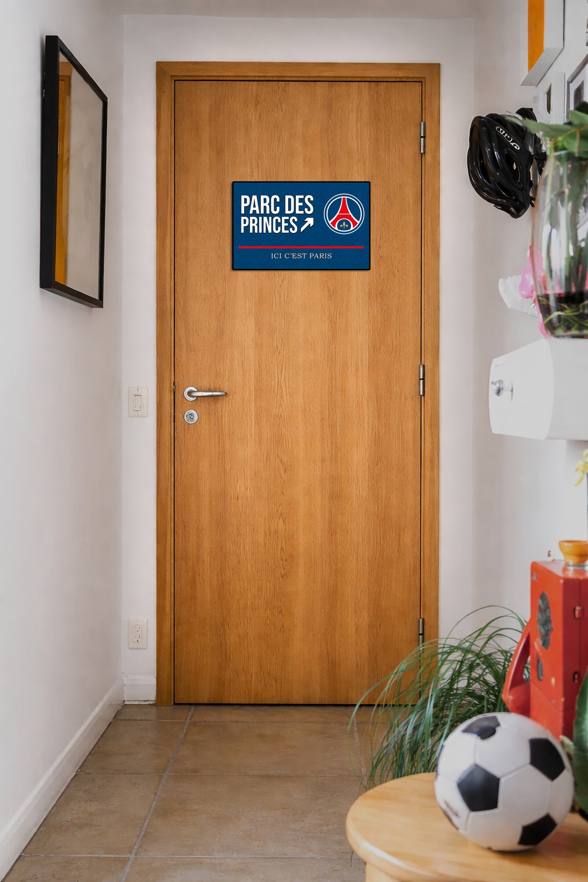 Wooden door with a Parc des Princes sign in a hallway