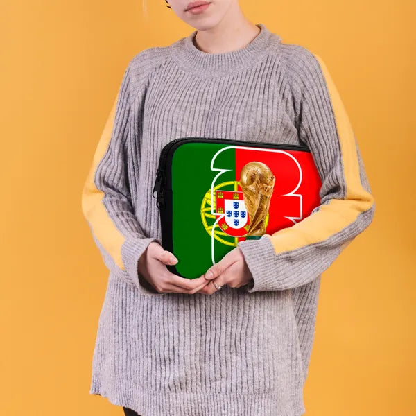Person holding a laptop case with a design of a flag and a trophy on an orange background