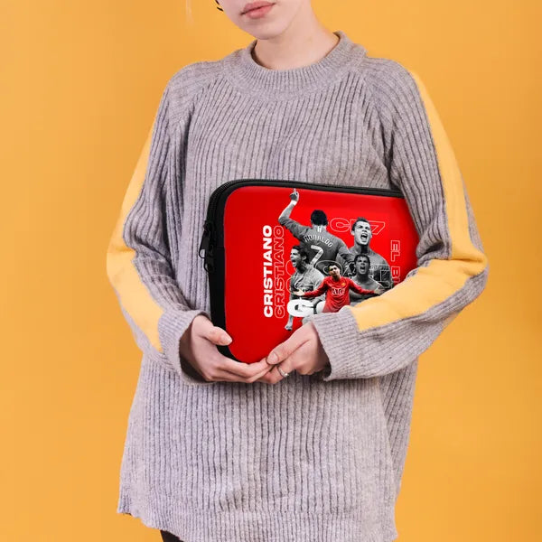 Person holding a red Cristiano Ronaldo branded case against a yellow background