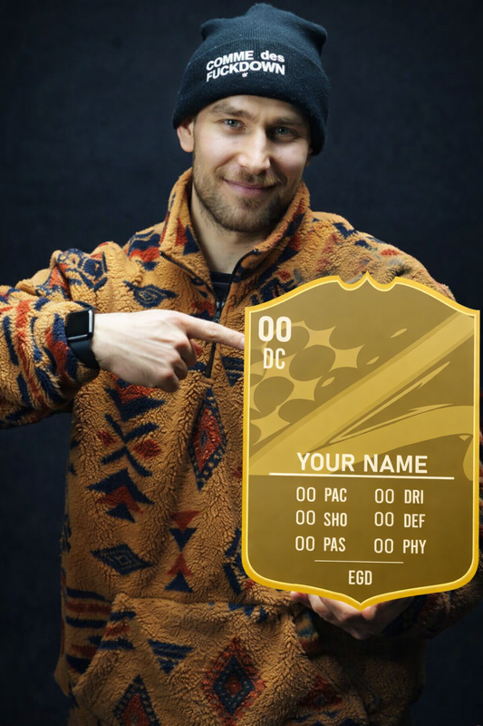 Man wearing a patterned jacket and beanie holding a gold card with text